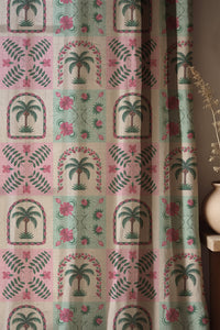 Soft folds of a pink and mint palm tile curtain