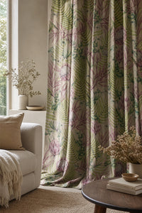 Pink protea and fern curtain on a black rod by a window