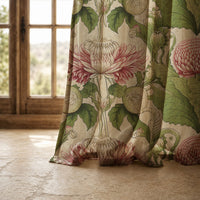 Hem of a pink thistle arts and crafts curtain resting on a stone floor