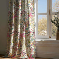 Full-length pink tropical lily curtain draping to a wooden floor