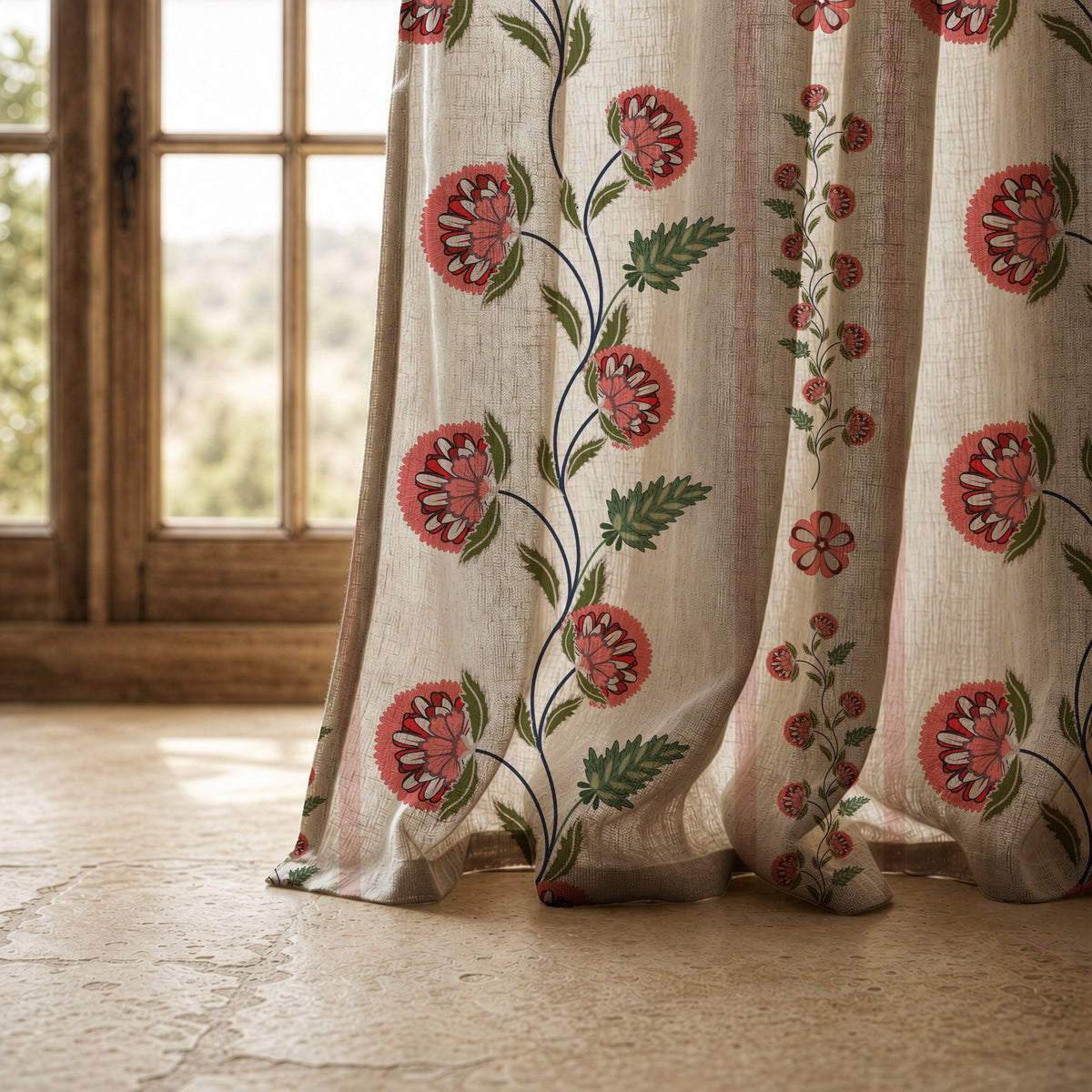 Hem of a pomegranate vine stripe curtain resting on a stone floor