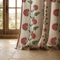 Hem of a pomegranate vine stripe curtain resting on a stone floor