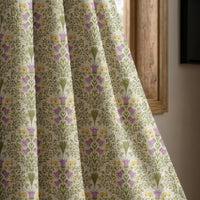 Purple thistle ditsy curtain panel beside a rustic wooden window