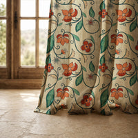 Hem of a red floral vine curtain resting on a stone floor