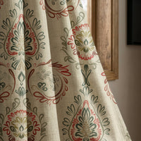 Red and green folk damask curtain panel beside a rustic wooden window