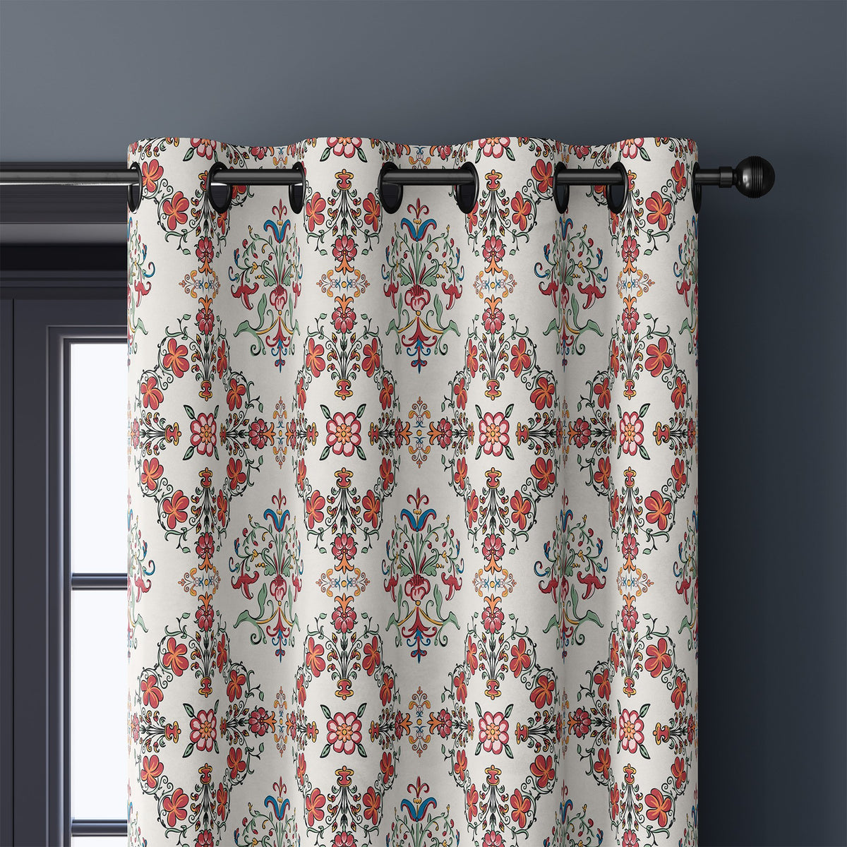 Close-up of red medallion tile curtain grommets on a black rod