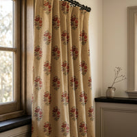 Red poppy block print curtain on a black rod by a window