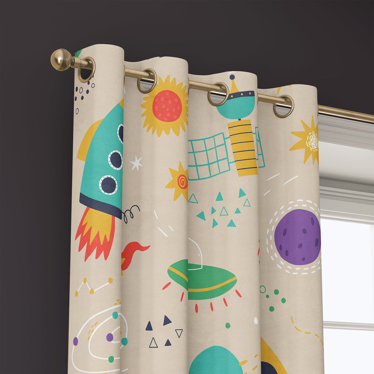 Grommet top of a retro rocket space kids curtain on a brass rod