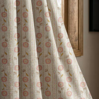 Rose pink floral stripe curtain panel beside a rustic wooden window