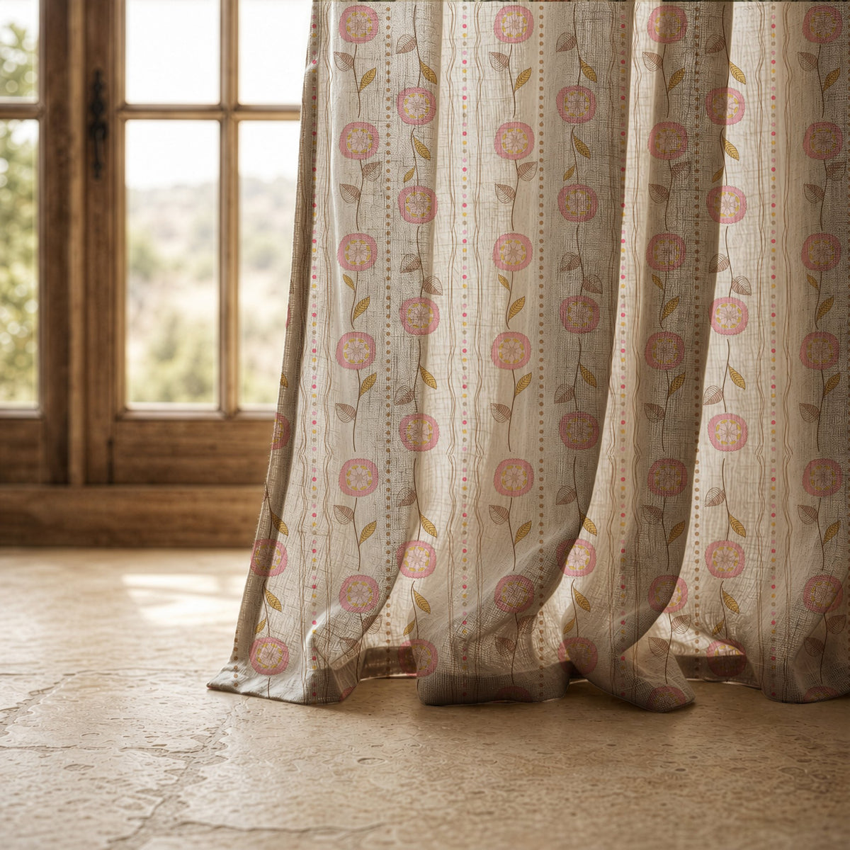 Hem of a rose pink floral stripe curtain resting on a stone floor