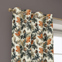 Grommet top of a rust and green oak leaf curtain on a brass rod