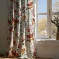 Full-length rust red orchid floral curtain draping to a wooden floor