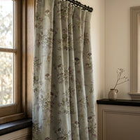 Sage blue vintage rose curtains in a warm living room