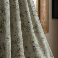 Sage blue vintage rose curtain panel beside a rustic wooden window