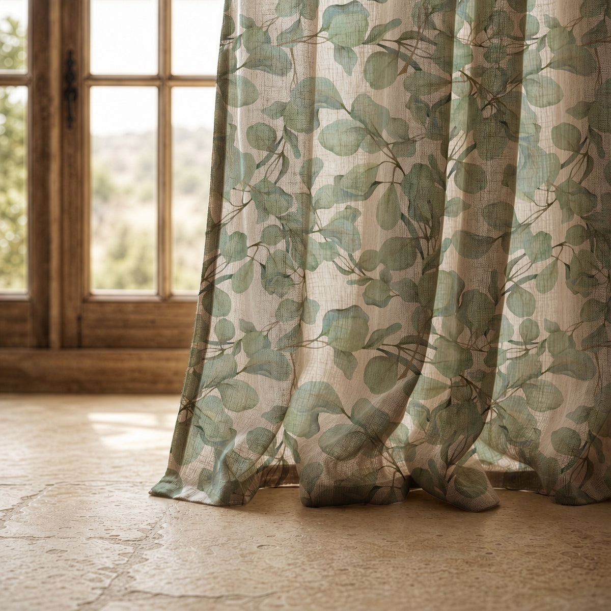 Hem of a sage eucalyptus leaf curtain resting on a stone floor