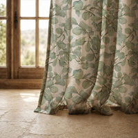 Hem of a sage eucalyptus leaf curtain resting on a stone floor