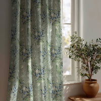 Sage green lavender sprig curtain beside a potted olive tree