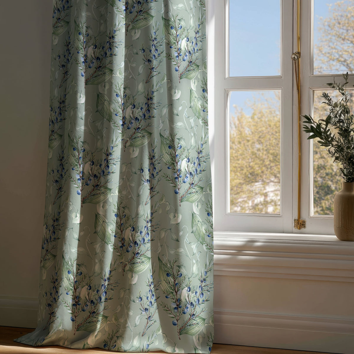 Full-length sage green lavender sprig curtain draping to a wooden floor