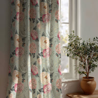 Sage green peony floral curtain beside a potted olive tree