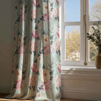 Full-length sage green peony floral curtain draping to a wooden floor
