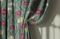 Sage green thistle and daisy curtain gathered to one side