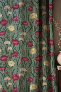 Soft folds of a sage green thistle and daisy curtain