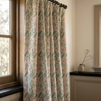Sage and pink ditsy floral curtains in a warm living room