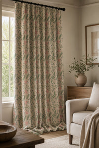 Sage and pink ditsy floral curtain on a black rod by a window