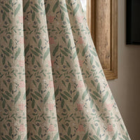 Sage and pink ditsy floral curtain panel beside a rustic wooden window