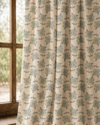 Pair of small blue block print floral curtains at an arched window