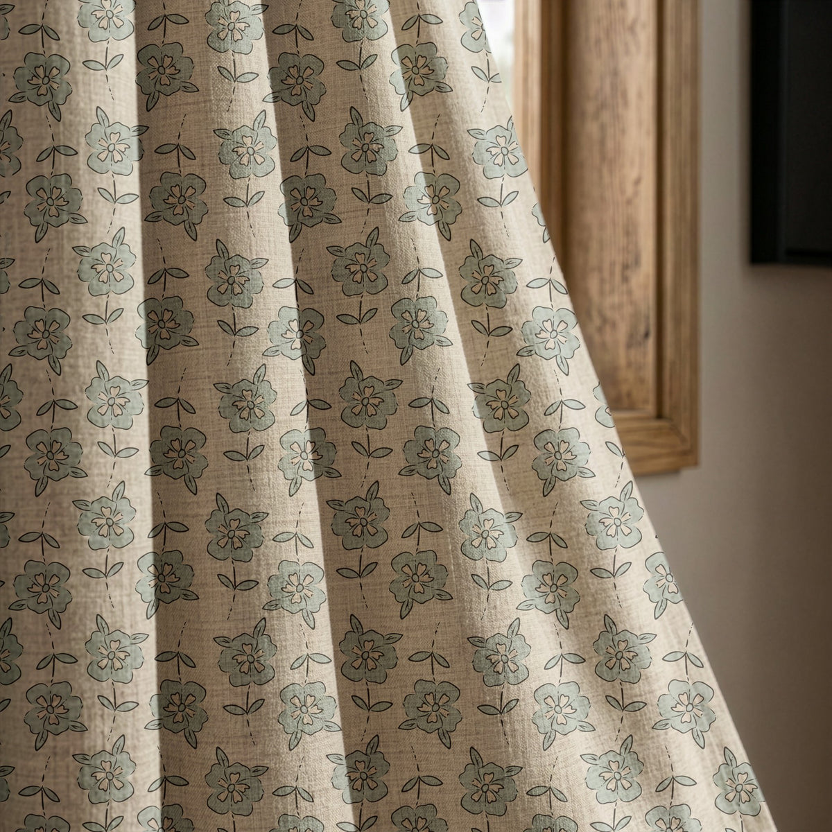 Small blue block print floral curtain panel beside a rustic wooden window
