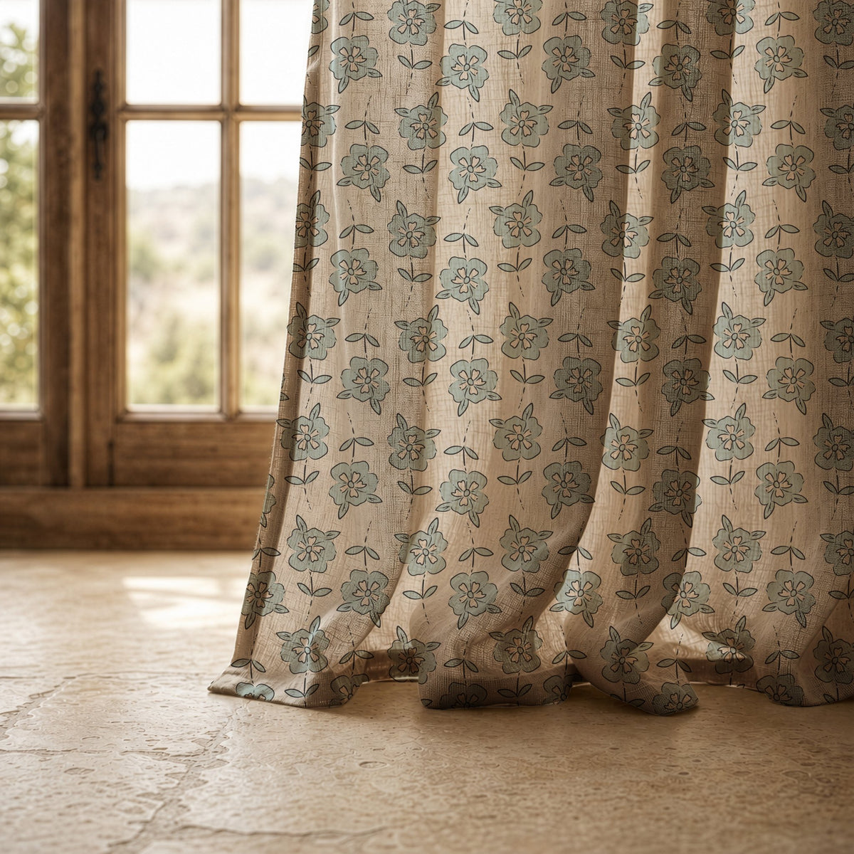 Hem of a small blue block print floral curtain resting on a stone floor, view 6