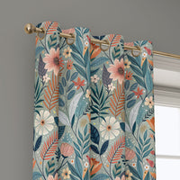 Grommet top of a teal art nouveau floral curtain on a brass rod