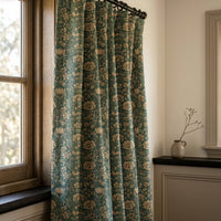 Teal arts and crafts floral curtains in a warm living room