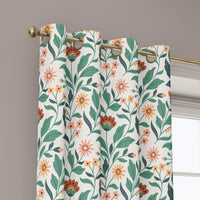 Grommet top of a teal and coral arts and crafts floral curtain on a brass rod