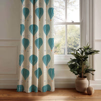 Teal hot air balloon nursery curtain panel hanging by a white window