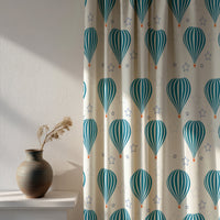 Soft daylight through a teal hot air balloon nursery curtain