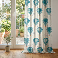 Teal hot air balloon nursery curtain at glass patio doors