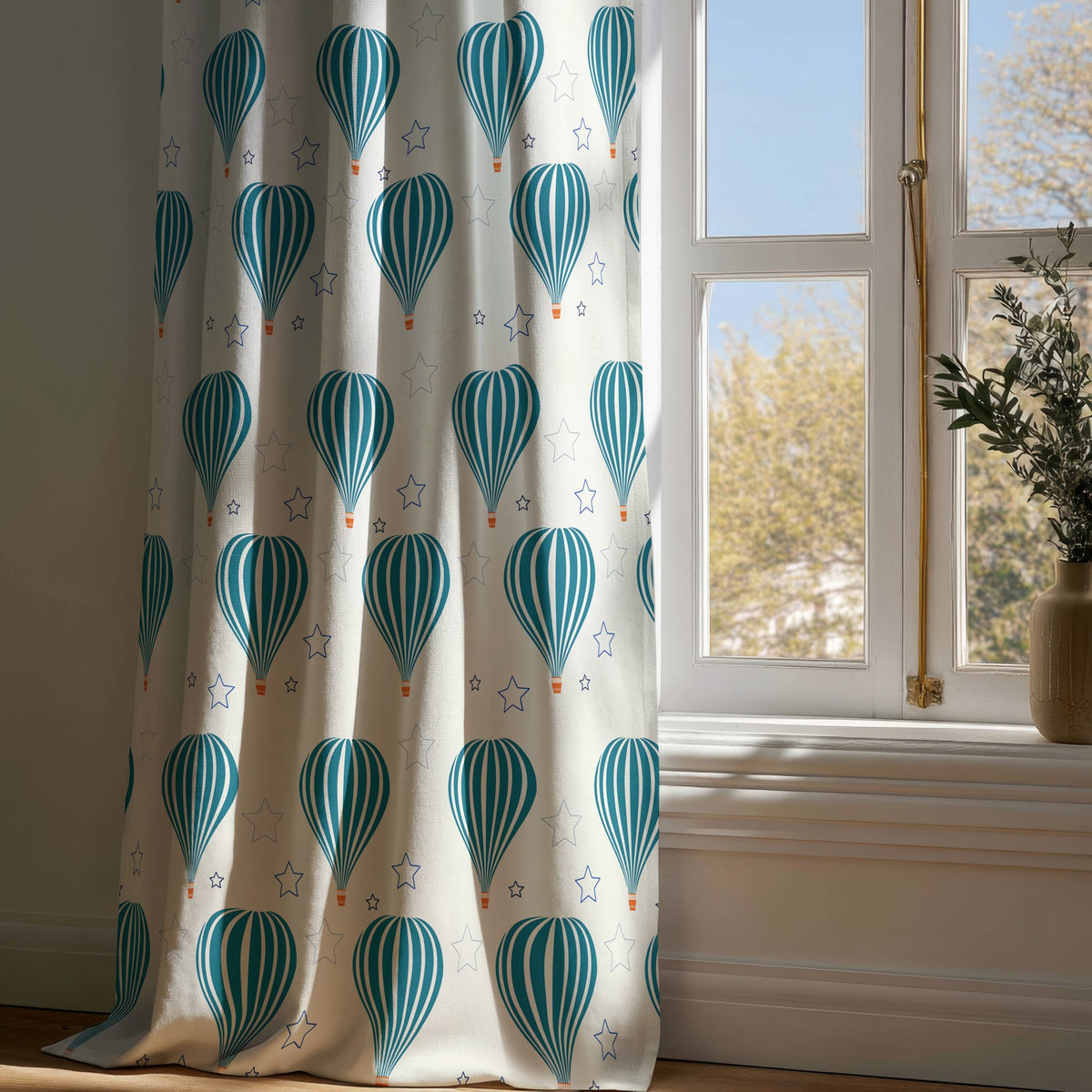 Full-length teal hot air balloon nursery curtain draping to a wooden floor