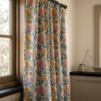 Teal and pink abstract floral curtains in a warm living room