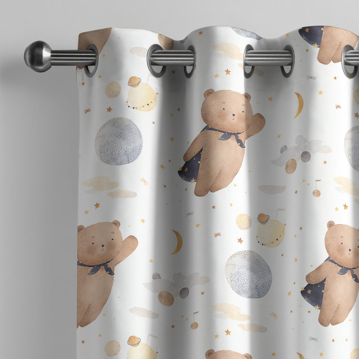 Teddy bear and moon nursery curtain on a grommet rod, close-up of the print