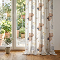 Teddy bear and moon nursery curtain at glass patio doors