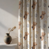 Soft daylight through a teddy bear and moon nursery curtain