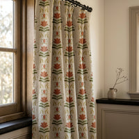 Terracotta folk tulip curtain on a black rod by a window