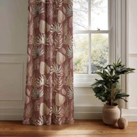 Terracotta palm leaf curtain panel hanging by a white window