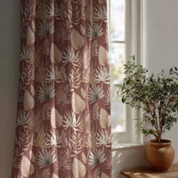 Terracotta palm leaf curtain beside a potted olive tree