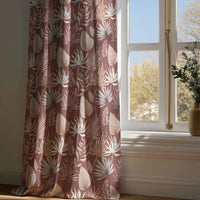 Full-length terracotta palm leaf curtain draping to a wooden floor