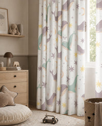 Whale nursery curtains framing a tall window