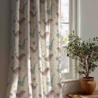 Whale nursery curtain beside a potted olive tree