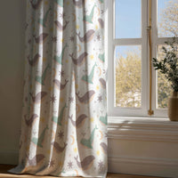 Full-length whale nursery curtain draping to a wooden floor